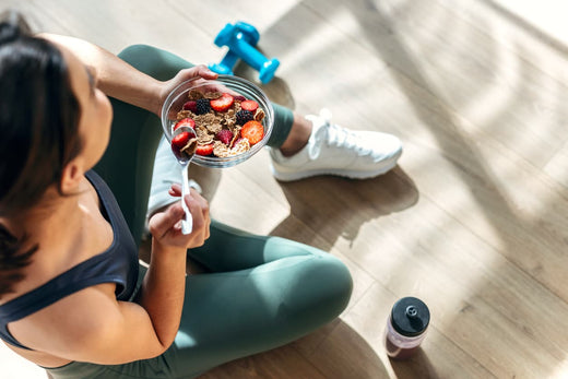 A young woman eating a healthy fruit salad as part of her weight loss journey