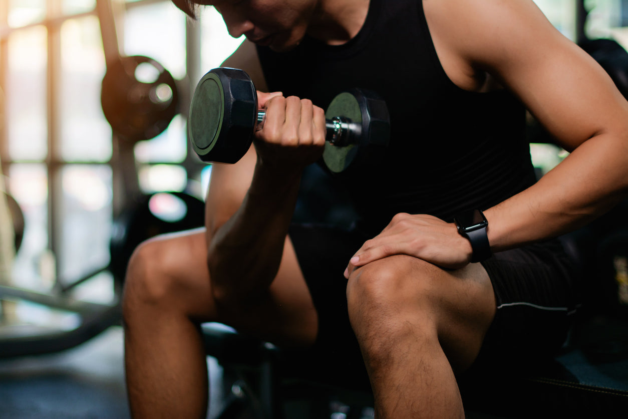 a man is doing dumbell bicep curl.